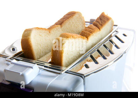 Tostare in un tostapane. Toast fritti fette all'interno del tostapane. Una vista ravvicinata di pasticceria in un dispositivo di tostatura. Foto Stock