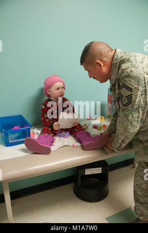 Senior Master Sgt. Daniel Rosales del 163d Ala di ricognizione, 163d Manutenzione aeromobili squadrone, offre giocattoli per i bambini che sono i pazienti all'Università di Loma Linda ospedale per bambini, Dic 14, 2012. Il aviatori dal California Air National Guard sono state sperando di poter visitare e illuminare la giornata dei bambini con doni come i bambini ricevono la cura al paziente in uscita centro in cui essi hanno spesso a visitare un paio di volte a settimana.(Air National Guard photo/Master Sgt. Julie Avey) Foto Stock