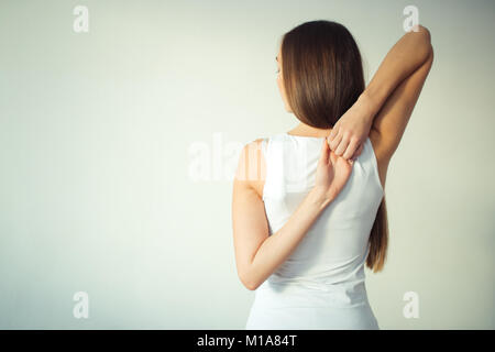 Vista posteriore di montare la donna facendo gomukhasana nella classe di yoga Foto Stock
