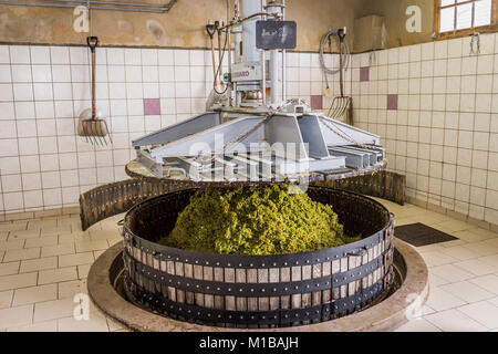 Hautvillers, Francia - 11 agosto 2017: Premendo le uve con un vecchio premere con due uomini in Pressoir nel villaggio di Champagne Hautvillers nea Foto Stock