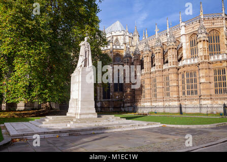 Statua di George V, re del Regno Unito e i domini britannici, e l'imperatore dell India in Palazzo vecchio cortile con l'Abbazia di Westminster in background Foto Stock