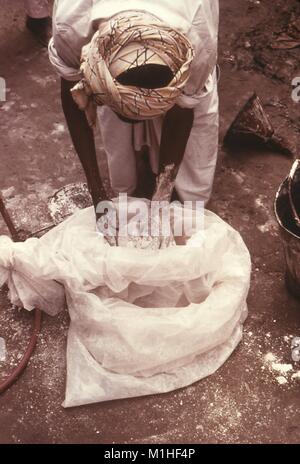 Fotografia di un controllo di malaria lavoratore la miscelazione dell'insetticida malathion a mano, Pakistan, 1976, 1977. Immagine cortesia CDC/Edward Baker, M.D. M.P.H. () Foto Stock