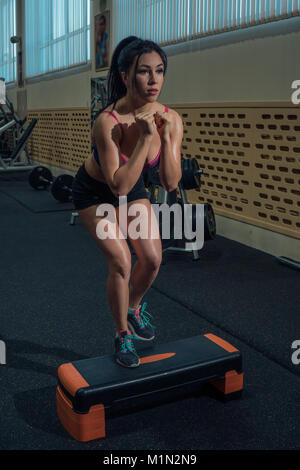 Bella bruna è mettere in pratica la fase aerobica in palestra. Cardio-training Foto Stock
