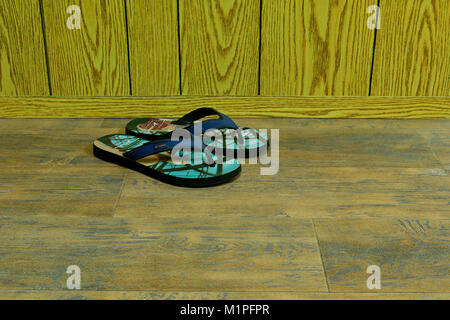 Sandali e infradito sul pavimento in legno Foto Stock