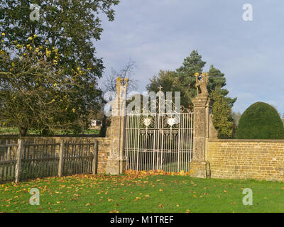 Il centro storico di cancelli e gatepiers ai giardini di Canons Ashby House come visto dalla strada al Eydon; Northamptonshire, Regno Unito Foto Stock