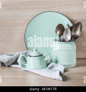 Il turchese stoviglie, posate, stoviglie e utensili da roba su piano in legno. Cucina ancora la vita come sfondo per il design. Immagine con copia spazio. Foto Stock