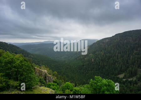 Francia - valle rocciosa nella foresta e paesaggio boscoso con pioggia nuvole Foto Stock