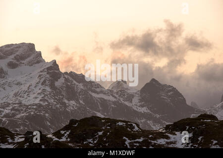 La luce del tramonto nelle montagne che circondano il villaggio di pescatori di Ramberg nelle Isole Lofoten in Norvegia Foto Stock