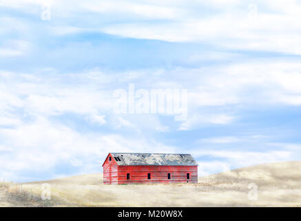 Granaio sulla collina nel campo nuvoloso Foto Stock