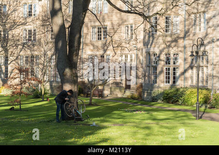 St Salvator's Hall - Studente riparazione bici fuori dai tradizionali saloni di soggiorno all'Università di St Andrews, Scotland, Regno Unito Foto Stock
