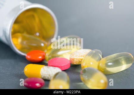 Pillole farmaceutiche versato all'esterno della bottiglia pillola closeup Foto Stock