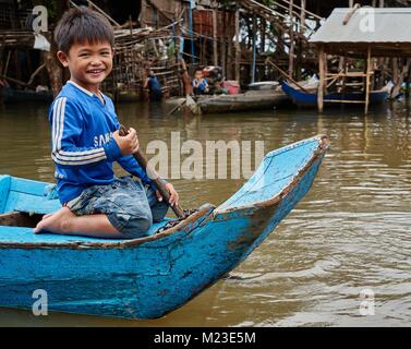 Bambini canottaggio nel villaggio galleggiante, Kompong Chhnang, Cambogia Foto Stock