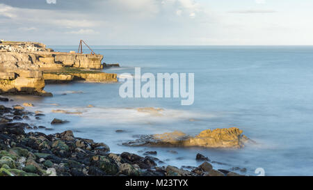 Sole splende sulle scogliere a sinistra da disuso lavorazioni di cava a Portland Bill nel Dorset in Inghilterra del Jurassic Coast. Foto Stock