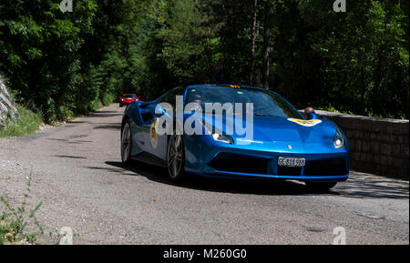 GOLA DEL FURLO, Italia - Ferrari 488 spider 2015 su una vecchia macchina da corsa nel rally Mille Miglia 2017 il famoso storico italiano della gara (1927-1957) a maggio Foto Stock