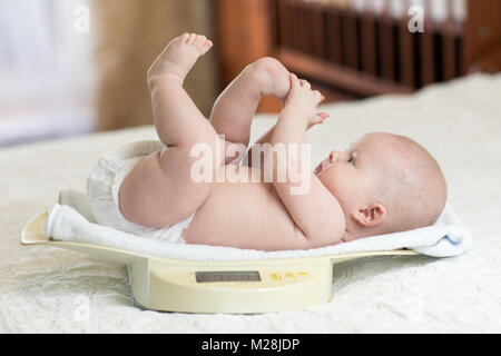 Carino piccolo neonato Bambino giacente su scale a casa Foto Stock