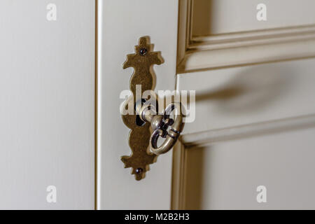 Chiave decorativa in un blocco su un armadio Foto Stock