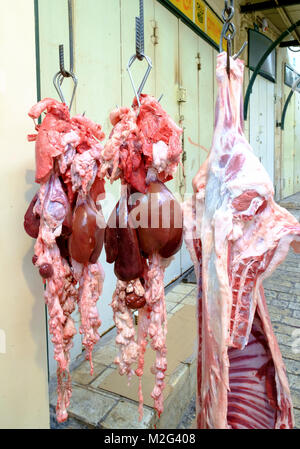 Carni fresche appesi da un rack in un piccolo a conduzione familiare macelleria. Fotografato a Nazaret, Israele Foto Stock