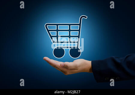 Imprenditore mano Cart shopping il mondo della tecnologia digitale per lo shopping delle transazioni su internet Trading sul mondo online pay dept. Le tonalità blu Foto Stock