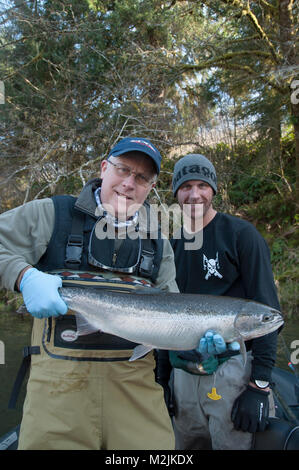 Trota Steelhead pescatori con un incubatoio allevati Siletz river steelhead catturati su un galleggiante guidato viaggio. Il modello release, solo uso editoriale. Foto Stock