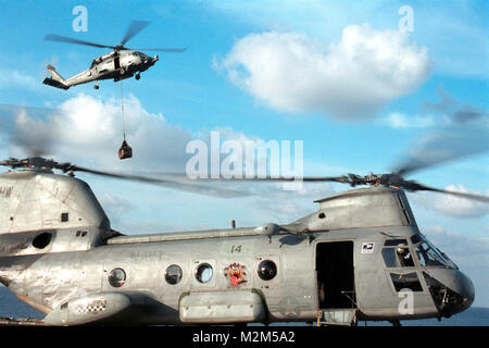 001026-N-9848G-003 a bordo della USS George Washington (26 ottobre 2000) -- Un CH-46 'Sea Knight' elicottero da combattimento veloce nave appoggio USS Alimentazione (AOE 6) si prepara a lanciare dal ponte di volo della portaerei USS George Washington (CVN 73), mentre una SH-60 'Sea Hawk' elicottero da "Red Lions' del gestore del elicottero imbarcato Anti-Submarine uno squadrone cinque (HS-15) eroga al carico di Washington durante un rifornimento verticale in mare (VERTREP). Il Norfolk, VA-based carrier è operativo nel Mar Mediterraneo. Stati Uniti Navy foto dal fotografo compagno del 3° di classe Carrie-A Foto Stock