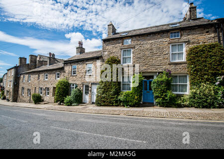 Riga della città storica case lungo carreggiata, Yorkshire Dales, REGNO UNITO Foto Stock