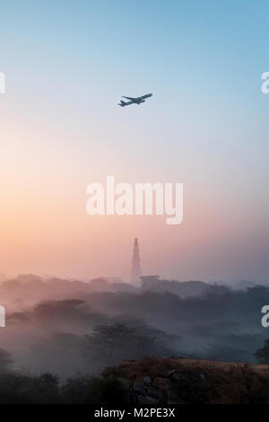 Un inizio di mattina inverno alba con uno strato sottile di nebbia al più iconica Qutub Minar nella città capitale di New Delhi Foto Stock