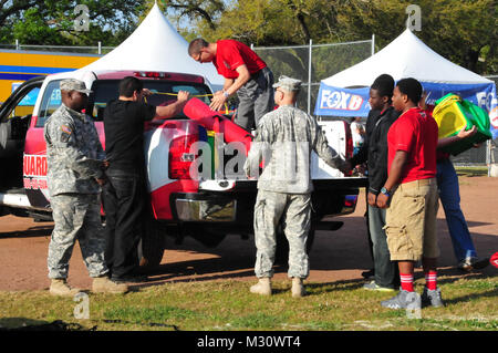 NEW ORLEANS - i soldati della Louisiana National Guard e guerrieri dal LANG le reclutare Supporto Programma fornire intrattenimento e omaggi per i partecipanti e i volontari del 2013 Allstate Sugar Bowl Crescent City Classic 10K gara presso il parco della città, a New Orleans, Marzo 30. (Guardia Nazionale foto di Spc. Tarell J. Bilbo, il reclutamento e la ritenzione del comando degli affari pubblici del rappresentante/RILASCIATO) 130330-Z-SM895 dalla Louisiana National Guard Foto Stock