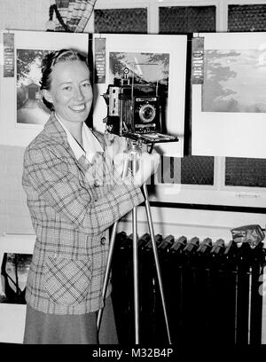 Fotocamera club donna pone con la sua velocità telecamera grafica, ca. 1956. Foto Stock