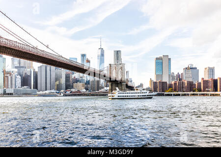 East River acqua con vista di NYC New York City cityscape skyline, ponte di Brooklyn, nave traghetto Barca nuoto da finanziario inferiore Quartiere di downtown cieli Foto Stock