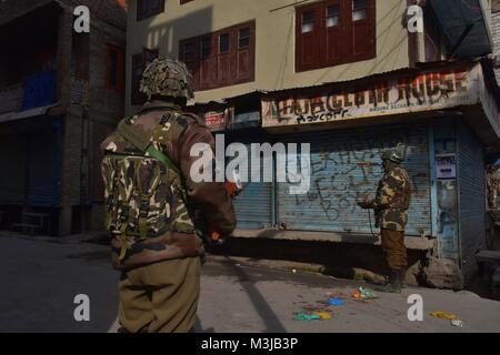 Srinagar, India. Xi Febbraio, 2018. Gruppi paramilitari di soldati di guardia durante le restrizioni a Srinagar, India Kashmir amministrato. Coprifuoco-simili restrizioni sono state imposte in parti di Srinagar città al seguito di una chiamata per sciopero dei gruppi separatisti per commemorare l anniversario della morte di Maqbool Bhat, il Jammu e Kashmir Liberation Front (JKLF) fondatore che fu impiccato in Delhi 34 anni fa.In altre parti della vallata, un arresto completo del sistema viene osservata. Negozi, stabilimenti commerciali sono chiusi e molto pochi veicoli sono visibili sulle strade.Maqbool Bhat fu impiccato il 11 febbraio, 1984 Foto Stock