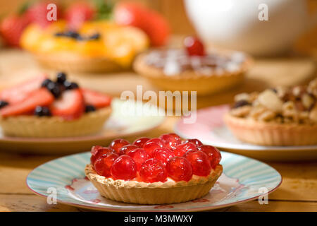 Una selezione di crostate di frutta con una ciliegia tart in primo piano Foto Stock