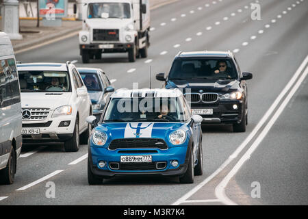 Minsk, Bielorussia - Aprile 7, 2017: Bianco e blu Mini Cooper Auto con Conducente Donna lo spostamento su strada Foto Stock