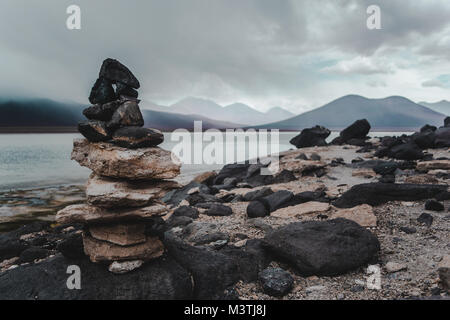 Stack di Rock / cairn sulla riva della Laguna Blanca in Eduardo Avaroa national park in Bolivia utilizzato dalle popolazioni indigene per marcare confini / percorsi Foto Stock