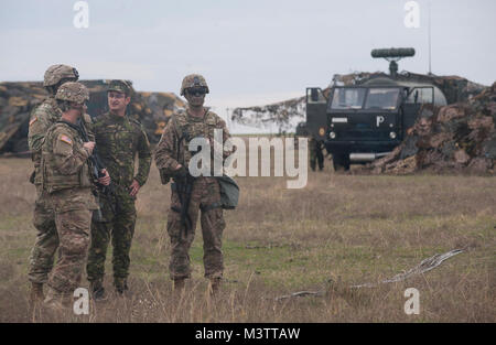 Stati Uniti I soldati dell esercito con il 5° Battaglione, settima la difesa aerea reggimento di artiglieria, parlare con membri rumeno della Air Force concernente il "falco" Sistema per missile durante un "Patriot Shock" esercizio di Capu Midia, Romania il 7 novembre 2016. Il giro delle prove di esercizio dell'unità di risposta rapido deployment readiness e aumenta l interoperabilità con "Patriot" Missile Systems e i loro partner rumeno. (DoD News foto da Tech. Sgt. Brian Kimball) 161107-F-QP401-054 dal DoD Notizie Foto Foto Stock