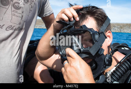 L'eliminazione degli ordigni esplosivi tecnico 1a classe Ruben Villegas, assegnato per l'eliminazione degli ordigni esplosivi unità mobile 5 (EODMU-5), indossa una maschera prima di condurre subacquei contromisure mine formazione in Apra Harbor, Guam, Febbraio 7, 2018. EODMU5 Contatore conduce operazioni di IED, rende sicuro rischi di esplosione e disarma underwater esplosivi. EODMU-5 è assegnato al comandante, Task Force 75, il primario expeditionary task force responsabile per la pianificazione e la realizzazione di zone costiere operazioni fluviali, l'eliminazione degli ordigni esplosivi, immersioni subacquee di ingegneria e costruzione, e costruzione subacquea Foto Stock