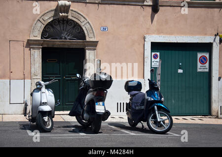 Tre cicli motore parcheggiato negli appositi alloggiamenti parkinig, Verona, Italia Foto Stock