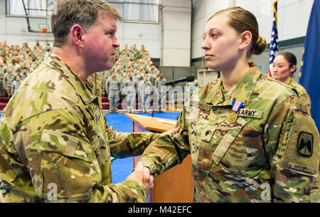 Stati Uniti Esercito Alaska comandante generale, il Mag. Gen. Mark O'Neil si congratula con SPC. Rosalind Stromberg dopo aggiudicazione suo soldato medaglia durante una cerimonia a Fort Wainwright, Alaska, 8 febbraio 2018. Spc. Stromberg ha ricevuto il premio per il salvataggio di un uomo di vita dopo una valanga mortale vicino a delta giunzione, Alaska il 3 aprile 2016. Dopo il trattamento la vittima per lo shock e prevenire l'ipotermia rimase con lui per cinque ore, a temperature di congelamento fino a quando i servizi di emergenza sono arrivati. (U.S. Esercito Foto Stock