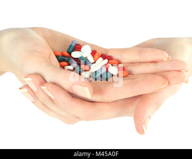 Pila di pillole diverse nelle mani della donna isolato su bianco Foto Stock