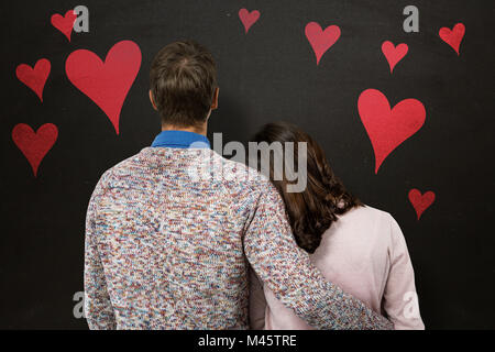 Immagine composita della vista posteriore del giovane in piedi Foto Stock