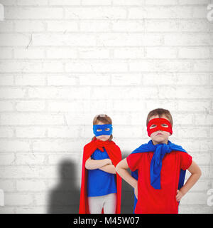 Immagine composita mascherata di bambini che fanno finta di essere supereroi Foto Stock