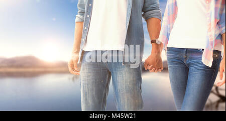 Immagine composita di hip coppia giovane Holding Hands Foto Stock