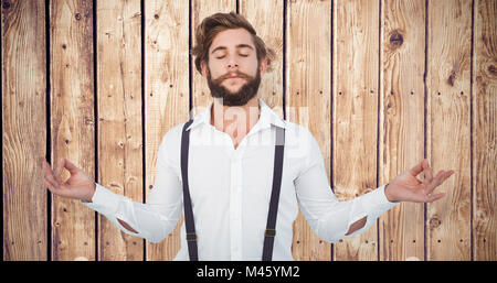 Immagine composita del hipster meditando le braccia aperte Foto Stock