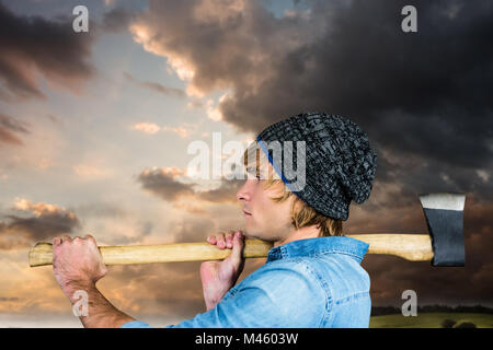 Immagine composita della vista laterale del hipster in piedi con ax Foto Stock