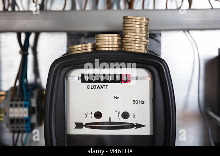 Close-up di un bottone impilato sulla misurazione di Kilowatt contatore elettrico Foto Stock