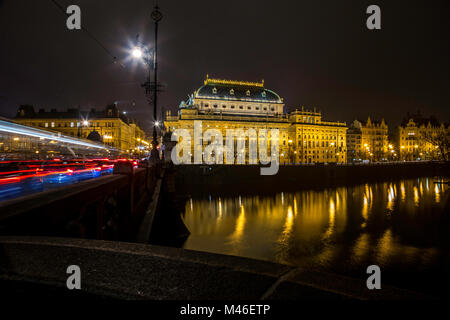 Vista notturna del fiume Moldava terrapieno con la dominante del Teatro Nazionale edificio a Praga, Repubblica Ceca Foto Stock