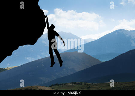 Silhouette di un uomo arrampicate sulle Rocky Mountain Foto Stock