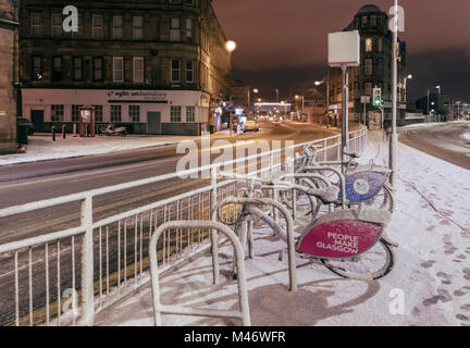 Pubblico noleggio bicicletta dalla stazione di Glasgow city di notte dopo una caduta di neve, Scotland, Regno Unito Foto Stock