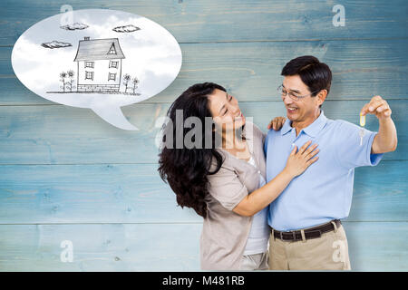 Immagine composita della coppia sorridente in possesso di un set di chiavi Foto Stock