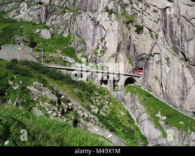 Express San Gottardo treno su Teufelsbruecke nei pressi di Andermatt in Svizzera, Devil's ponte ferroviario e tunnel, alpi svizzere, alpine montagne rocciose terra Foto Stock