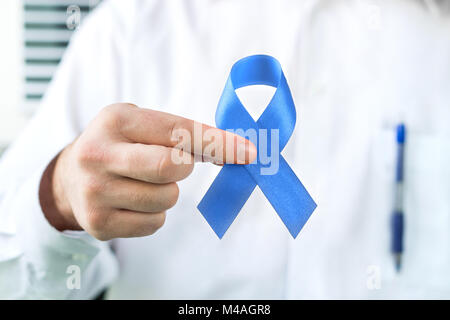 Il cancro della prostata la consapevolezza del concetto. Medico tenendo premuto il nastro blu.